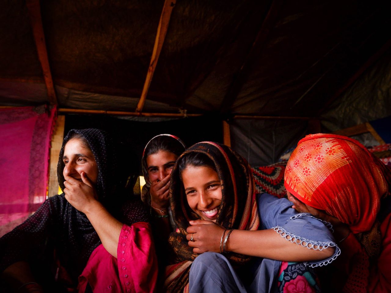 Young women burst into laughter when the conversation turns to menstruation in Chandipora area of central Kashmir on the outskirts of Srinagar. Since it is a taboo among the tribal community to not talk about menstruation openly, the women are shy and find it funny to speak about their experiences. Date: 9 April, 2022.