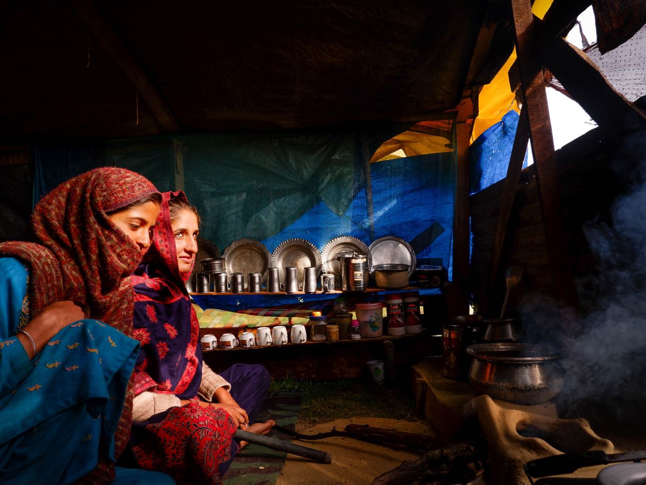 Kausar, 16 (left), and Rukhsana, 18, in their tent in Chandipora. “Cooking, fetching water and just gossiping makes our day fun.” Date: 9 May, 2022.
