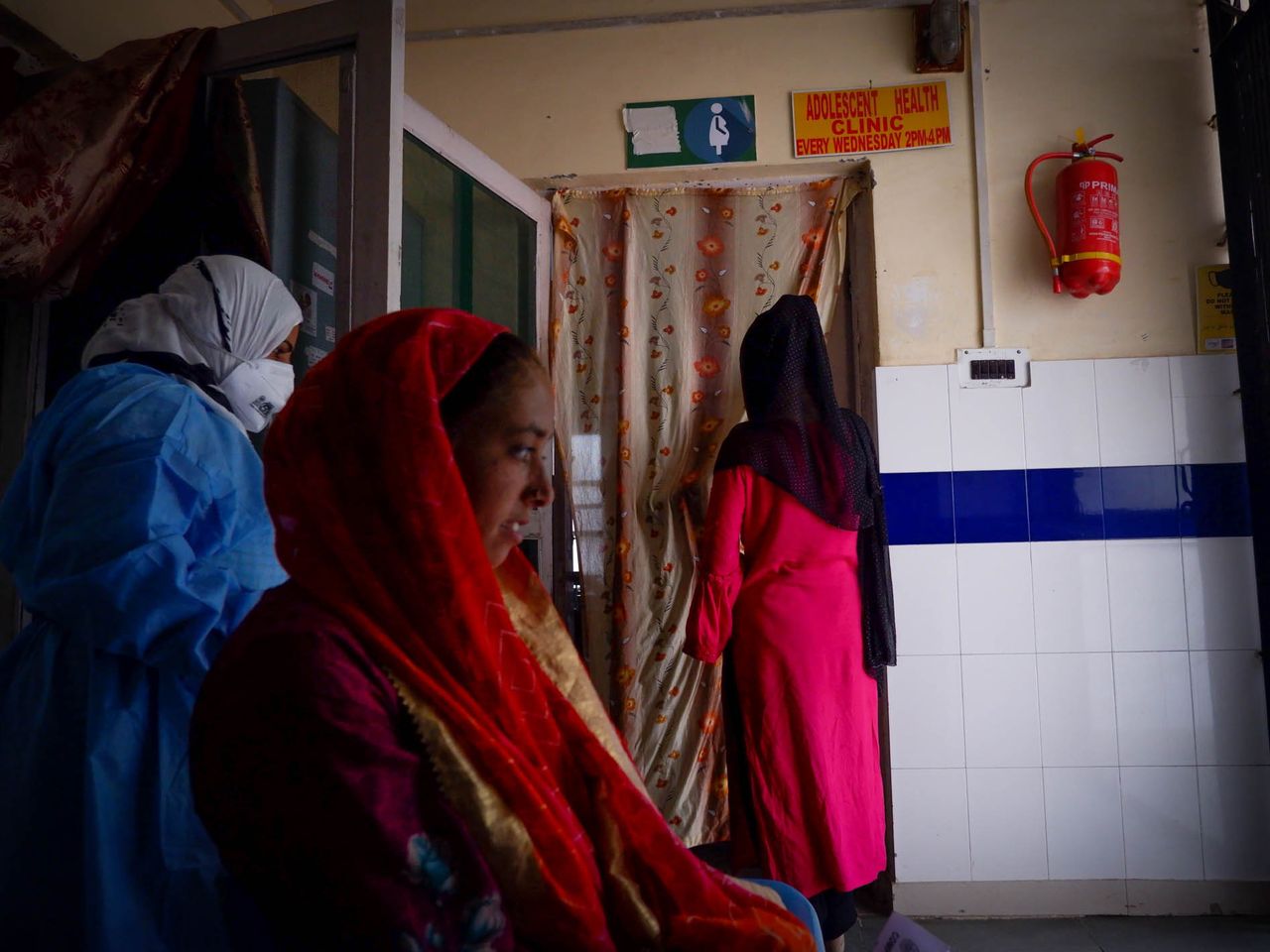 Young tribal women wait at a local government hospital in Harwan area of Kashmir. Date: 28 April, 2022.