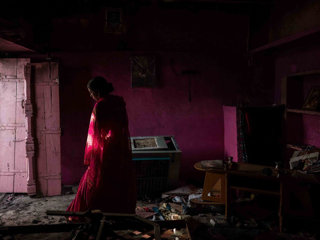 Asha Pawar a resident of a Hindu dominated cluster inspects her house that was set alight by a mob following a communal violence that broke out after a religious Hindu procession passed a block housed by Muslim minorities in Khargone in India's Madhya Pradesh state on April 16, 2022.